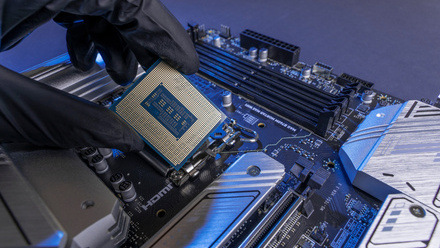 Computer processor in a gloved hand against the background of the motherboard iStock-1769166746.jpg 1